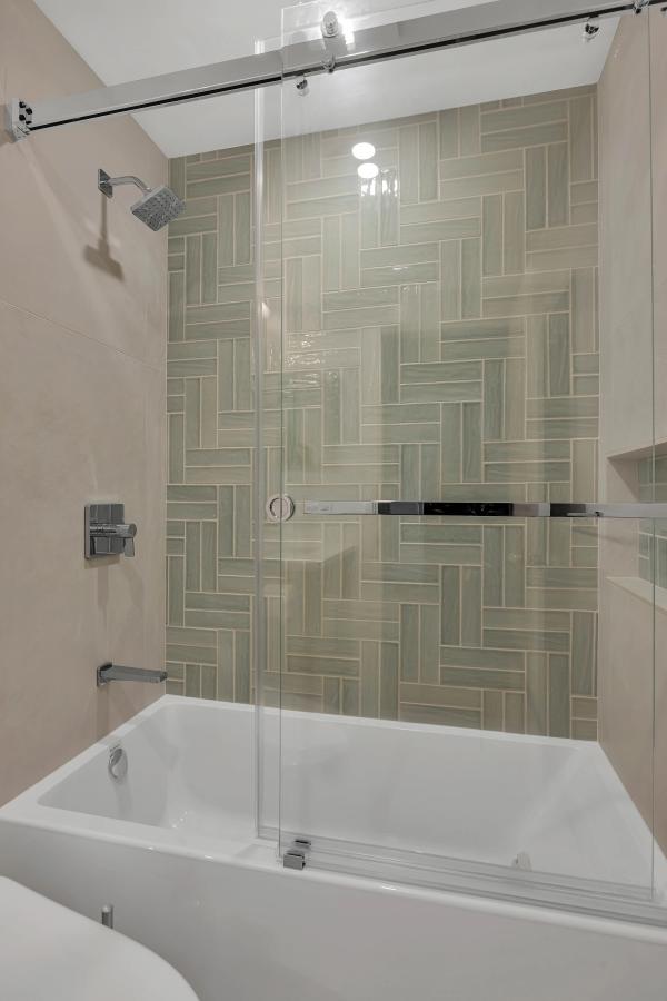 Stanford hall bathroom — basketweave tile tub surround with sliding glass