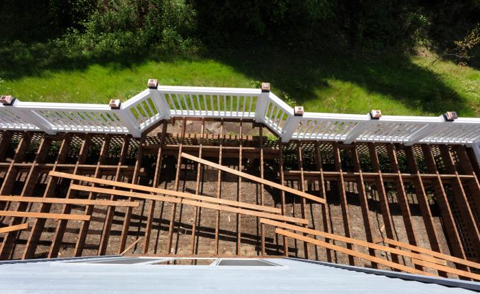 Deck rebuild — new cedar boards going down over reframed structure