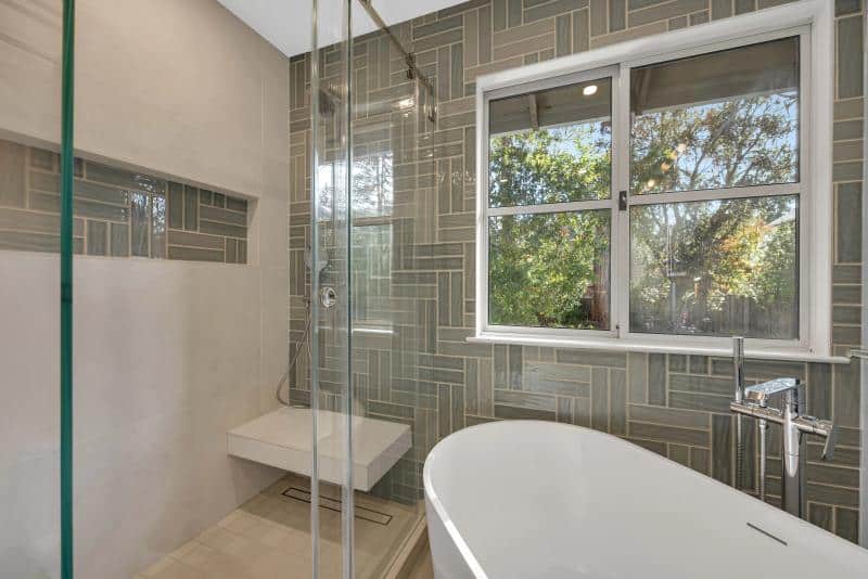 Stanford master bath — wide view with window and tub