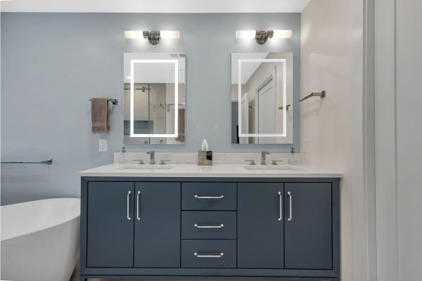 Stanford master bath — navy vanity with LED mirrors