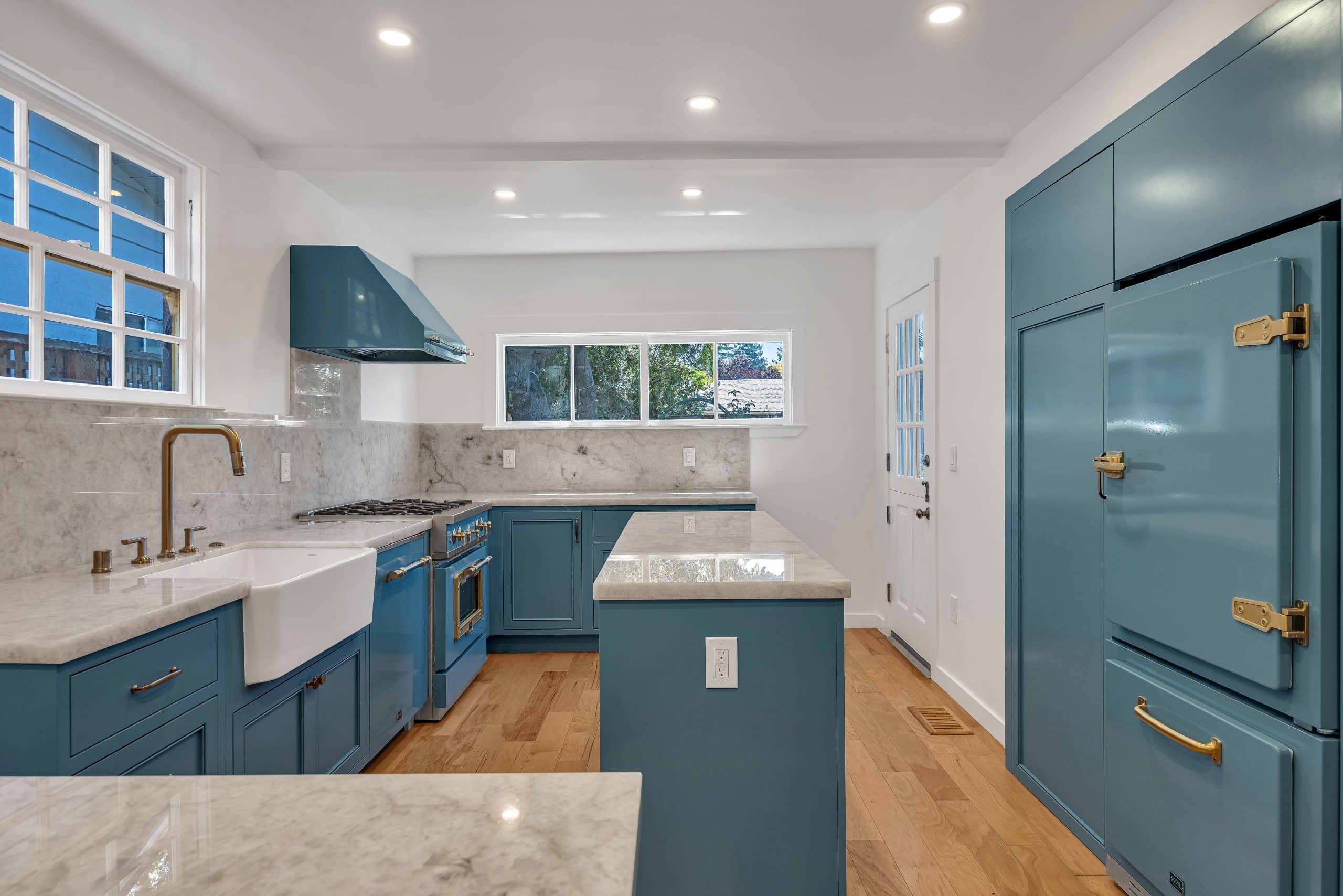 Menlo Park kitchen remodel — teal-blue cabinetry, marble island, and hardwood floors