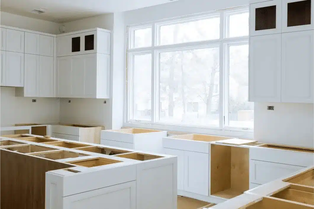 White kitchen cabinets with open boxes and exposed wood interiors, large windows behind, in a San Carlos kitchen remodel.